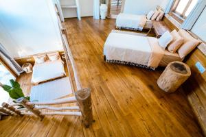 an aerial view of a room with a bed and a couch at Casa Asachai - Stylish bohemian retreat - Balangan in Uluwatu +28 photos