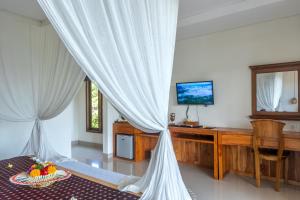 TV a/nebo společenská místnost v ubytování Mahadana Ubud