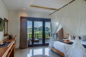 Postel nebo postele na pokoji v ubytování Mahadana Ubud
