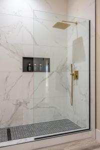 a bathroom with a shower with a glass door at Spacious 4BR, Pool, Jacuzzi, Pickleball, Sauna, Cold Plunge in Desert Hot Springs