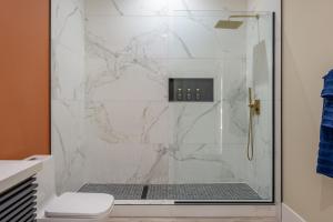a bathroom with a shower with white marble at Spacious 4BR, Pool, Jacuzzi, Pickleball, Sauna, Cold Plunge in Desert Hot Springs