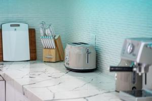 a kitchen counter with a toaster on a counter top at Spacious 4BR, Pool, Jacuzzi, Pickleball, Sauna, Cold Plunge in Desert Hot Springs