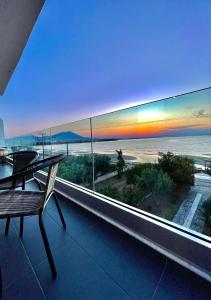 a balcony with a table and a view of the beach at Luxury Apartment Sea View Chalkida in Chalkida