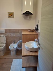 a bathroom with a sink and a toilet at Villa Margherita in Chia +20 photos