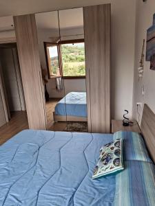 a bedroom with a bed and a large mirror at Villa Margherita in Chia