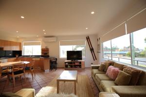 a living room with a couch and a table at 2 Munyang Street in Jindabyne