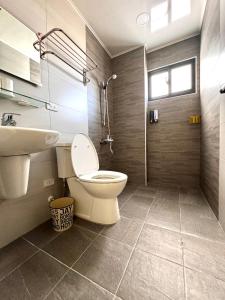 a bathroom with a toilet and a sink and a shower at Travel Happiness Homestay in Huxi