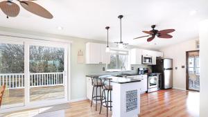 a kitchen with white cabinets and a counter top at Sunset Retreat in North Cape May