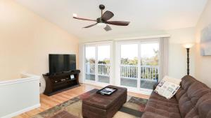 a living room with a couch and a flat screen tv at Sunset Retreat in North Cape May