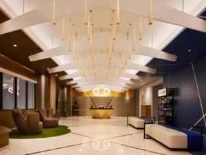a lobby with a large chandelier in a building at ES CON FIELD HOKKAIDO HOTEL Kitahiroshima Station in Kitahiroshima