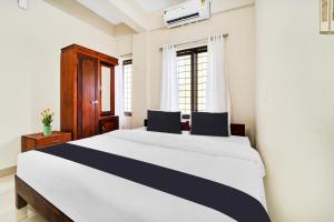 Postel nebo postele na pokoji v ubytování Super Hotel O Ambalamedu