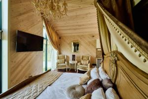a bedroom with a bed in a room with wooden walls at Сімейний Екопарк Ясногородка in Yasnogorodka