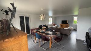 a living room with a table and a couch at La Lémania in Messery