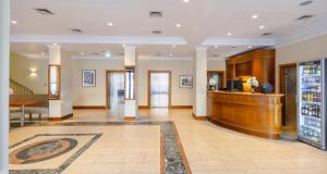 a lobby of a hotel with a drink counter at Best Western Hotel Leipzig City Centre in Leipzig