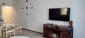 a living room with a flat screen tv on a wall at Anthic 7 Apartment 3 in Sozopol