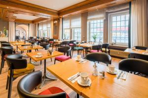 a restaurant with wooden tables and chairs at Best Western Hotel Würzburg-Süd in Würzburg