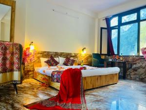 a hotel room with a bed and a large window at Hotel Bollywood in Kasol +27 photos