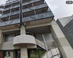 a building with a spiral staircase in front of it at #10 Nagoya Sunflower Condominium in Yadachō