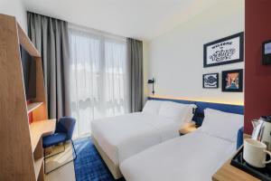 TV a/nebo společenská místnost v ubytování Hampton By Hilton Venice Isola Nuova
