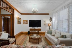 a living room with a couch and a tv at Franklin Lodge Huon Valley Iris Room in Franklin +36 photos