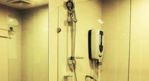 a shower in a bathroom with a phone on the wall at Adel Hotel in Kota Kinabalu +17 photos