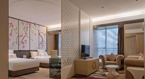 a hotel room with a bedroom and a living room at Zhongshan Da Dong Yu Hotel in Zhongshan +213 photos