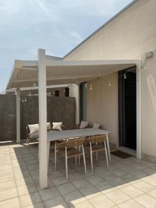 a patio with a table and chairs on a roof at Demetrio By Alma Suites in Valencia