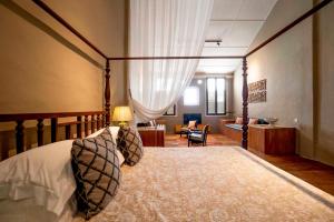 a bedroom with a bed and a living room at Argus Residences in George Town