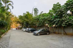 a row of cars parked in a parking lot at Treebo Premium Niraali Executive, Hinjewadi in Pune