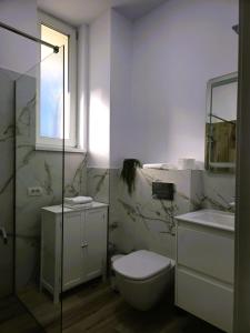 a white bathroom with a toilet and a sink at N&D Arinis Studio in Gura Humorului +16 photos