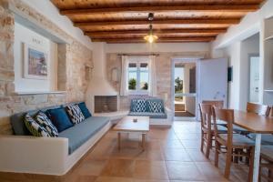 a living room with a couch and a table at Blue Xenia Villas Paros in Chrissi Akti