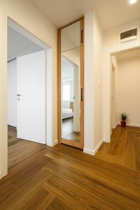 an empty room with a door and a mirror at North Panoramic Apartment in the art district of Kapana in Plovdiv