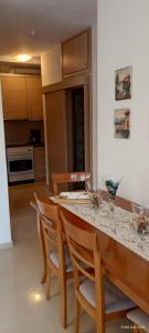 a kitchen with a table with chairs and a counter top at Armira House in Nea Moudania