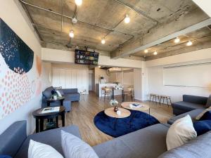 a living room with a couch and a table at b hotel Dai3Himawari - Amazing Dome View 30 sec PeacePark, Up to 10 ppl in Hiroshima