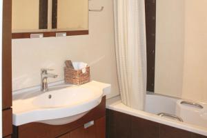 a bathroom with a sink and a bath tub at Villa Christina in Hanioti +9 photos