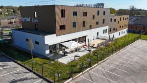 an overhead view of a building with a parking lot at Kyriad Limoges - Ester in Limoges
