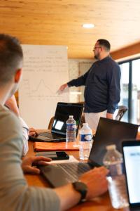 a group of people sitting at a table with laptops at Lou Cantou sur Lunain in Paley +96 photos