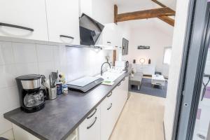 a kitchen with white walls and a counter top at Au cœur d'Amboise - Garage privé 2 roues in Amboise