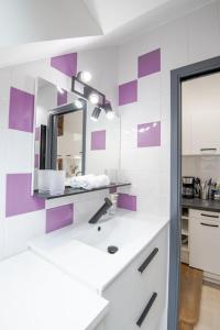 a bathroom with a sink and a mirror at Au cœur d'Amboise - Garage privé 2 roues in Amboise