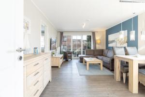 a living room with a couch and a table at Bellevue 02 in Laboe