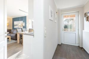 a kitchen and a living room with a table at Bellevue 02 in Laboe