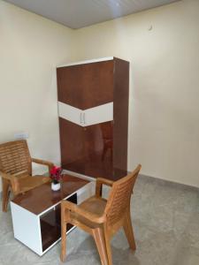 a living room with two chairs and a table at Shikhar camping bhandardara in Bhandāra