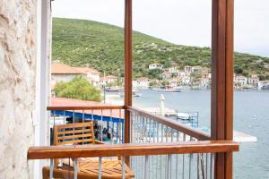 a balcony with a view of a body of water at Καταλυματα Selana και Ielios Trikerisuites in Trikeri