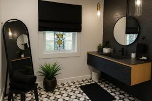 a bathroom with a sink and a mirror at NEW Hot tub, Fireplace, Swing, Modern Cabin in Eureka Springs +42 photos