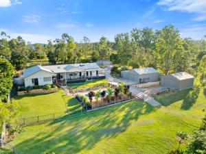 an aerial view of a house with a yard at Riverbend Ranch Tamborine in Tamborine