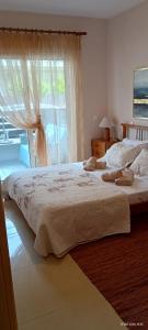 a bedroom with a large bed and a window at Armira House in Nea Moudania