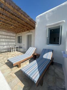 two benches on the patio of a house at Blue and White Mykonos ap2 in Mikonos +23 photos