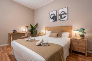 a bedroom with a large bed with towels on it at Sagrada familia Secret Apartment in Barcelona