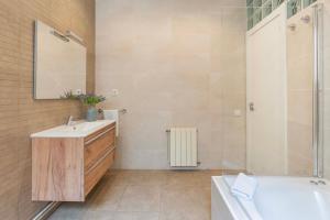 a bathroom with a tub and a sink and a shower at Sagrada familia Secret Apartment in Barcelona +35 photos