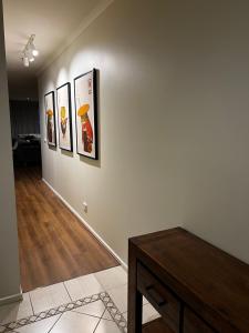 a hallway with four pictures on a wall at The Ryrie Loft in Geelong